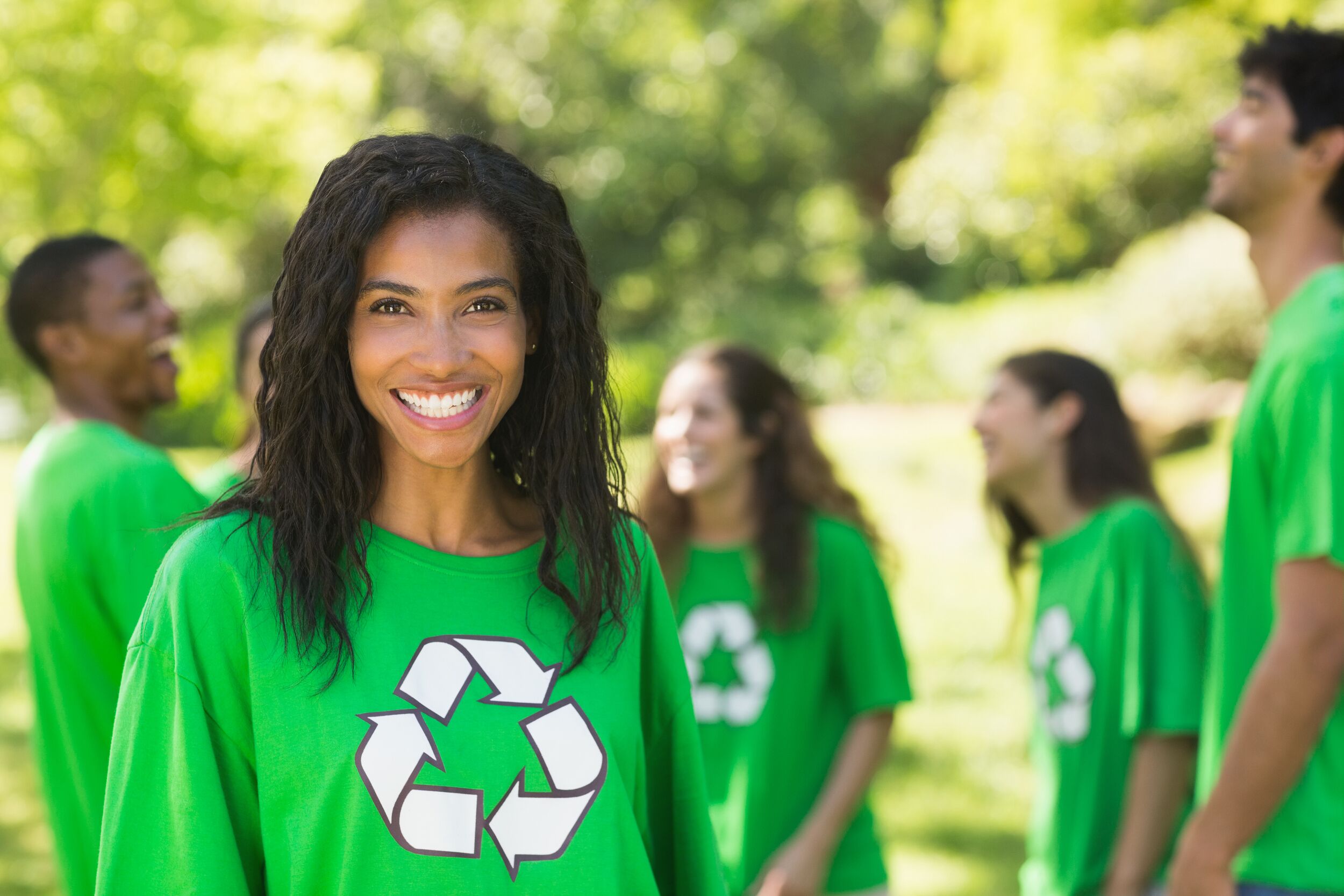 Portrait of a happy people wearing green recycling t-shirt in the park
